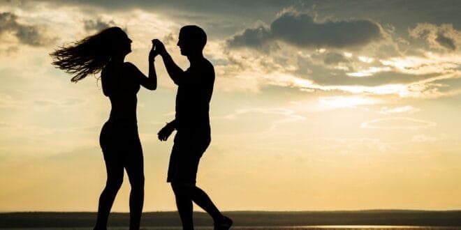 Two people salsa dancing outside