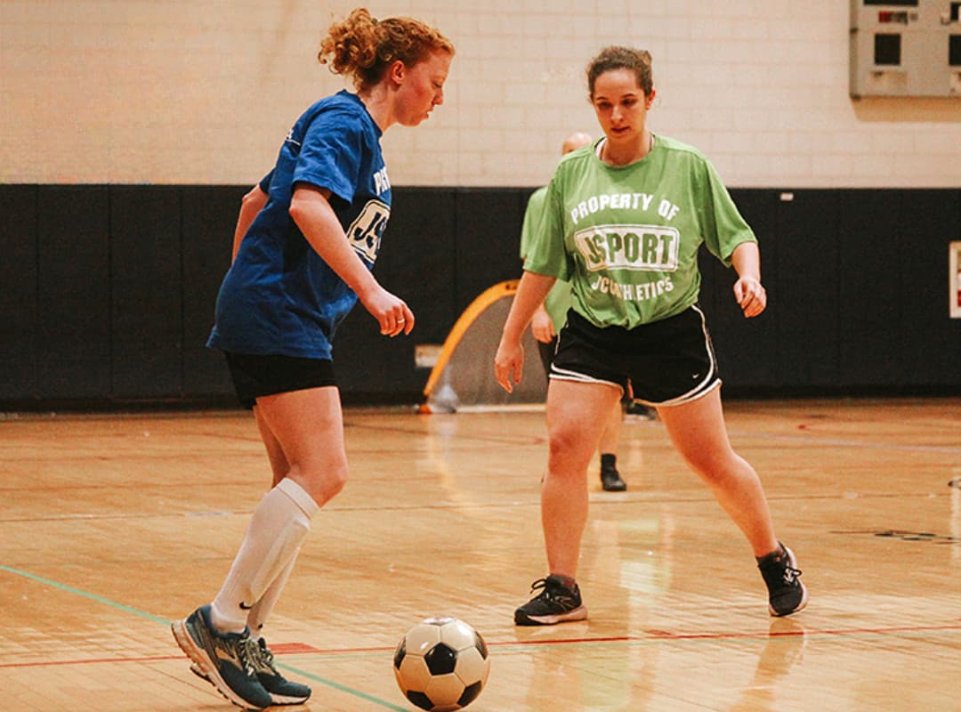 Two women playing soccer